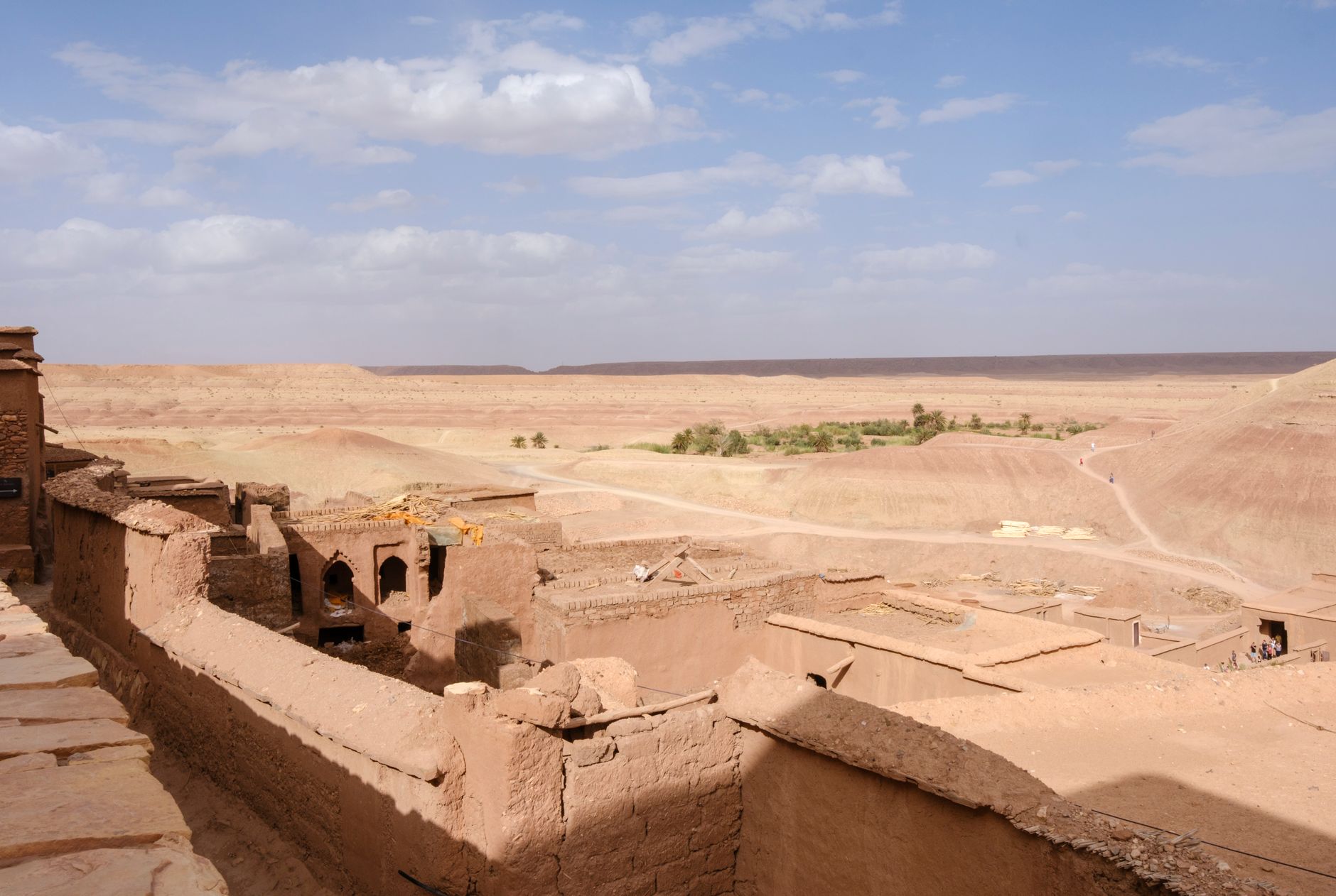 Traditional earthen ksar village nestled among rock formations in the Draa Valley region