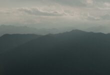 Mist rolling over a green mountain range in Sri Lanka's Knuckles highlands
