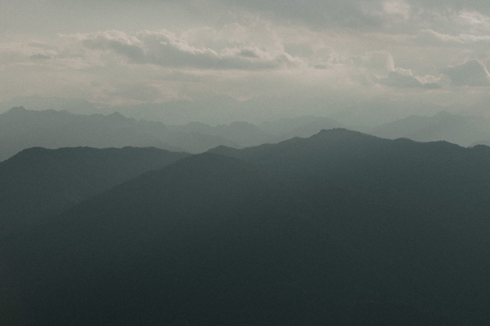 Mist rolling over a green mountain range in Sri Lanka's Knuckles highlands