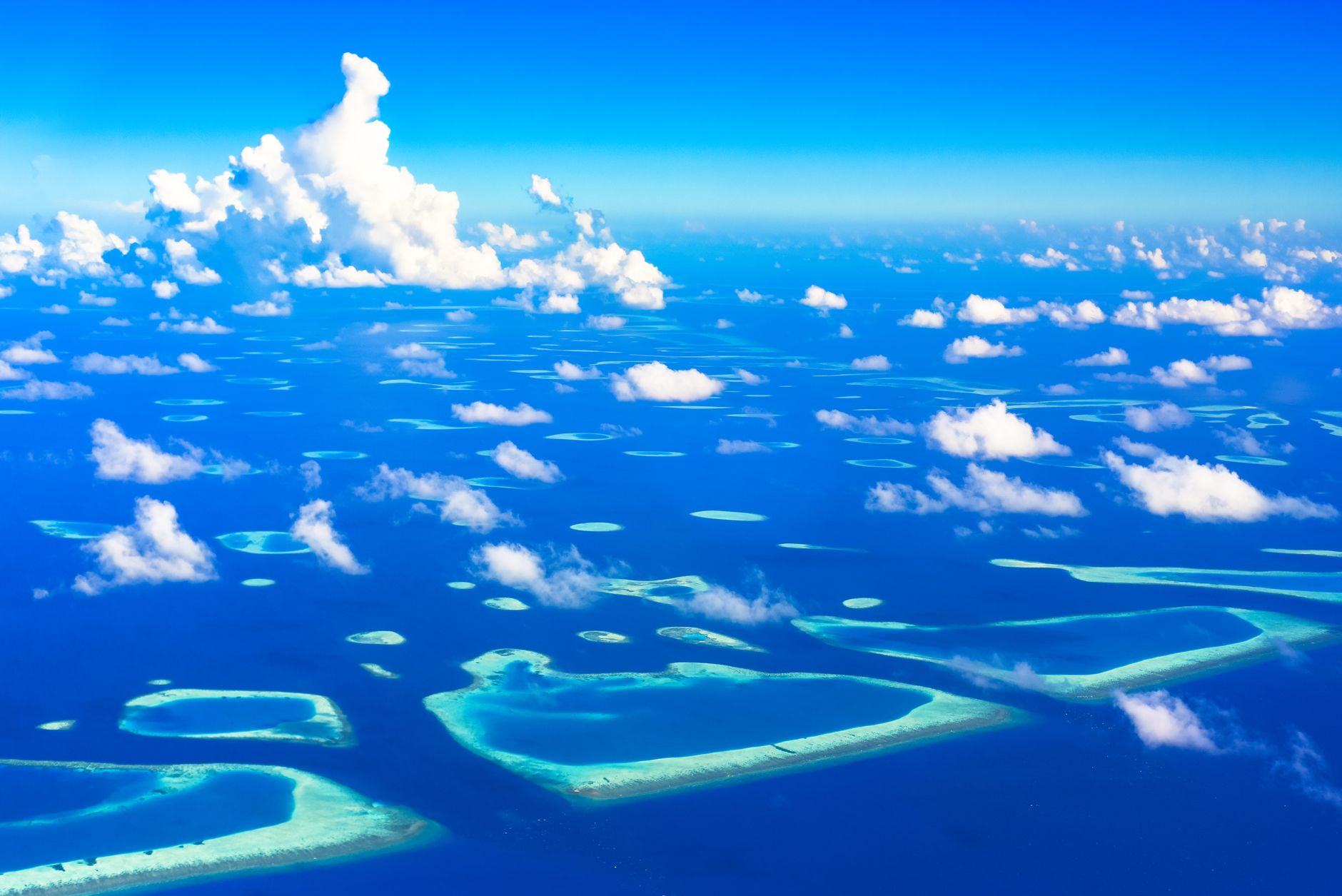 Aerial view of remote tropical islands surrounded by turquoise Andaman Sea water