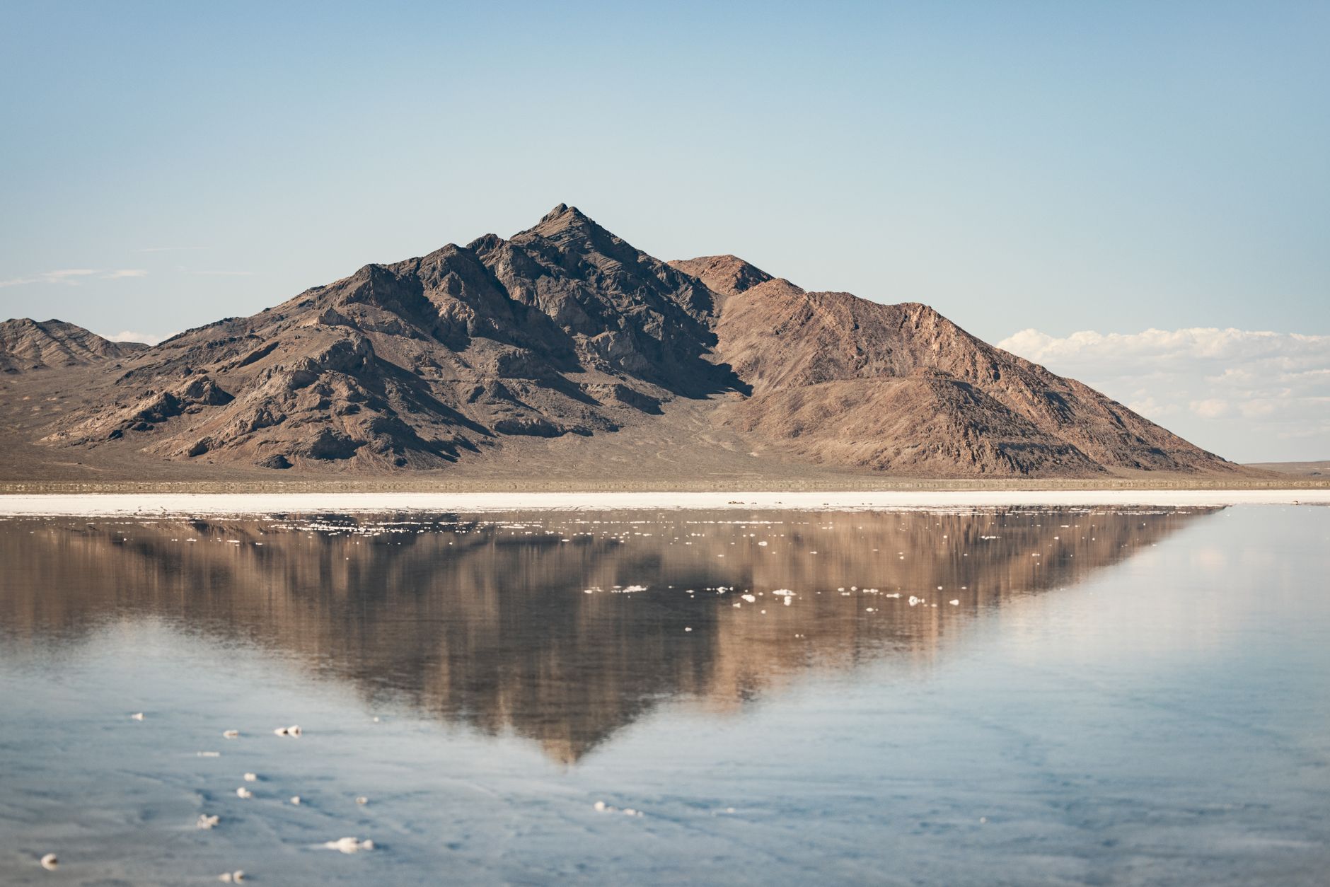 Vast white salt flat stretching to the horizon under a clear blue sky in Tunisia's Chott el-Djerid