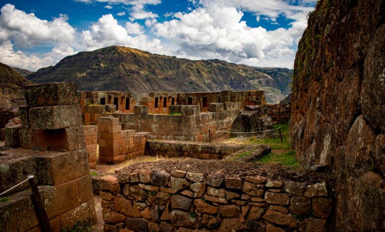 Ancient Inca stone terraces and ruins set against a mountainous jungle backdrop in Peru