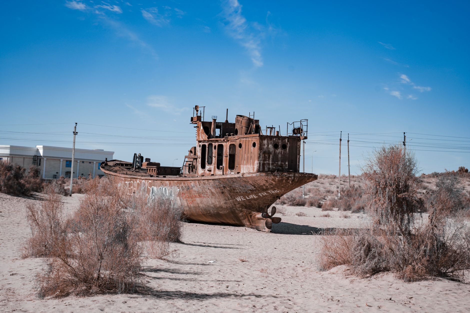 A rusted shipwreck half-buried in coastal desert sand along Namibia's Skeleton Coast
