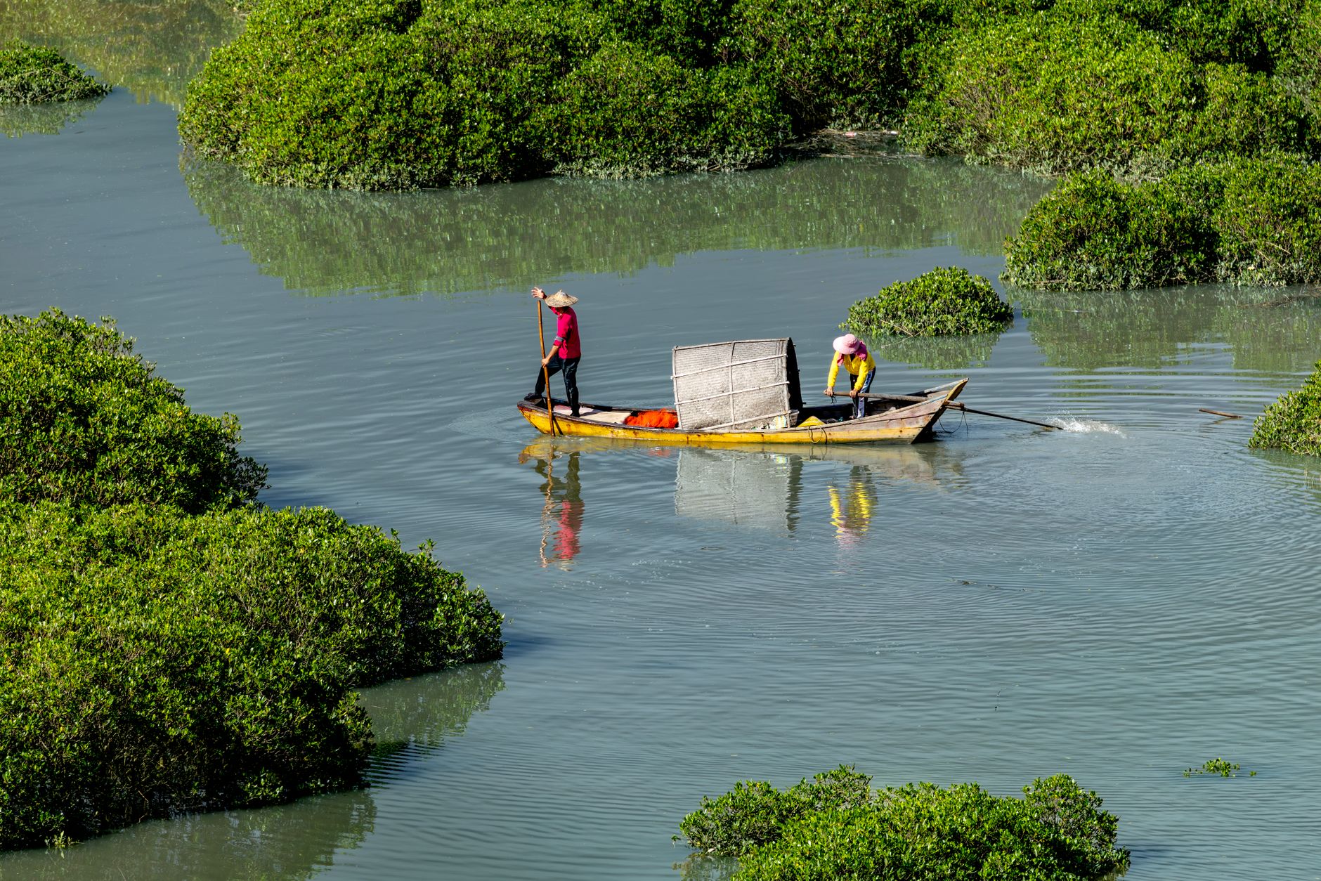 A mokoro dugout canoe drifting through a calm African floodplain waterway