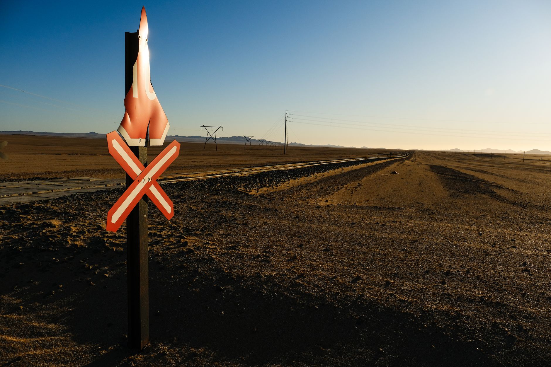 Heat mirage shimmering on a desert road crossing a flat arid landscape