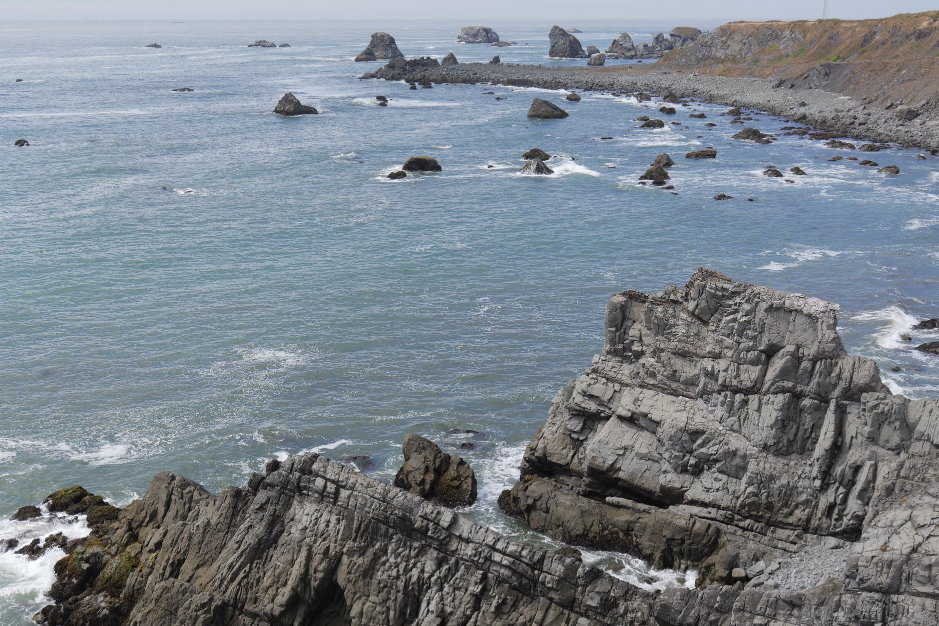 Limestone coastal cliffs with ocean waves near Al Mughsail beach in Dhofar, Oman