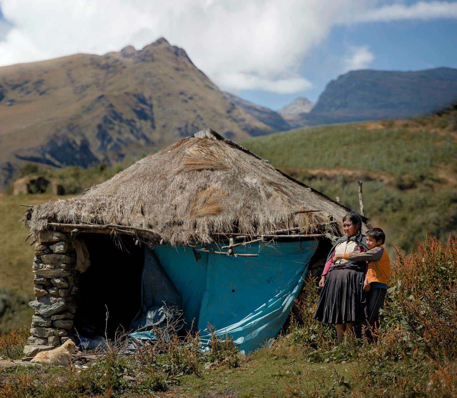 Traditional Andean community nestled in a valley surrounded by high mountain peaks in Bolivia