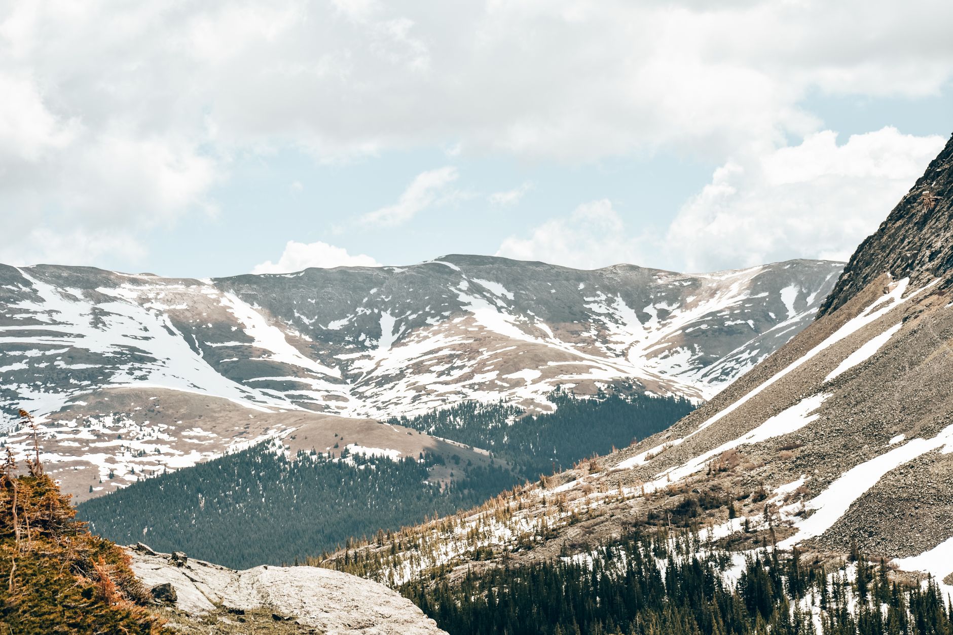 Dramatic rocky mountain landscape with steep cliffs and sparse vegetation