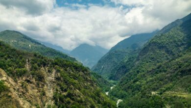 A remote Himalayan valley with terraced fields and snow-capped peaks in Nepal