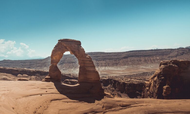 Massive natural sandstone arch rising above a desert landscape in the Sahara