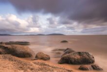 Clear blue waters of Lake Nyasa with rocky shoreline in Malawi