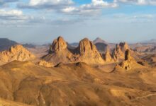 Vast sandstone plateau in the Saharan desert under a wide blue sky
