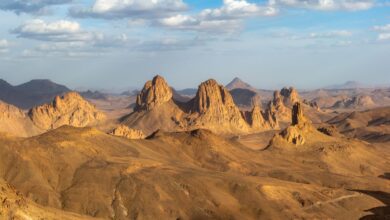 Vast sandstone plateau in the Saharan desert under a wide blue sky