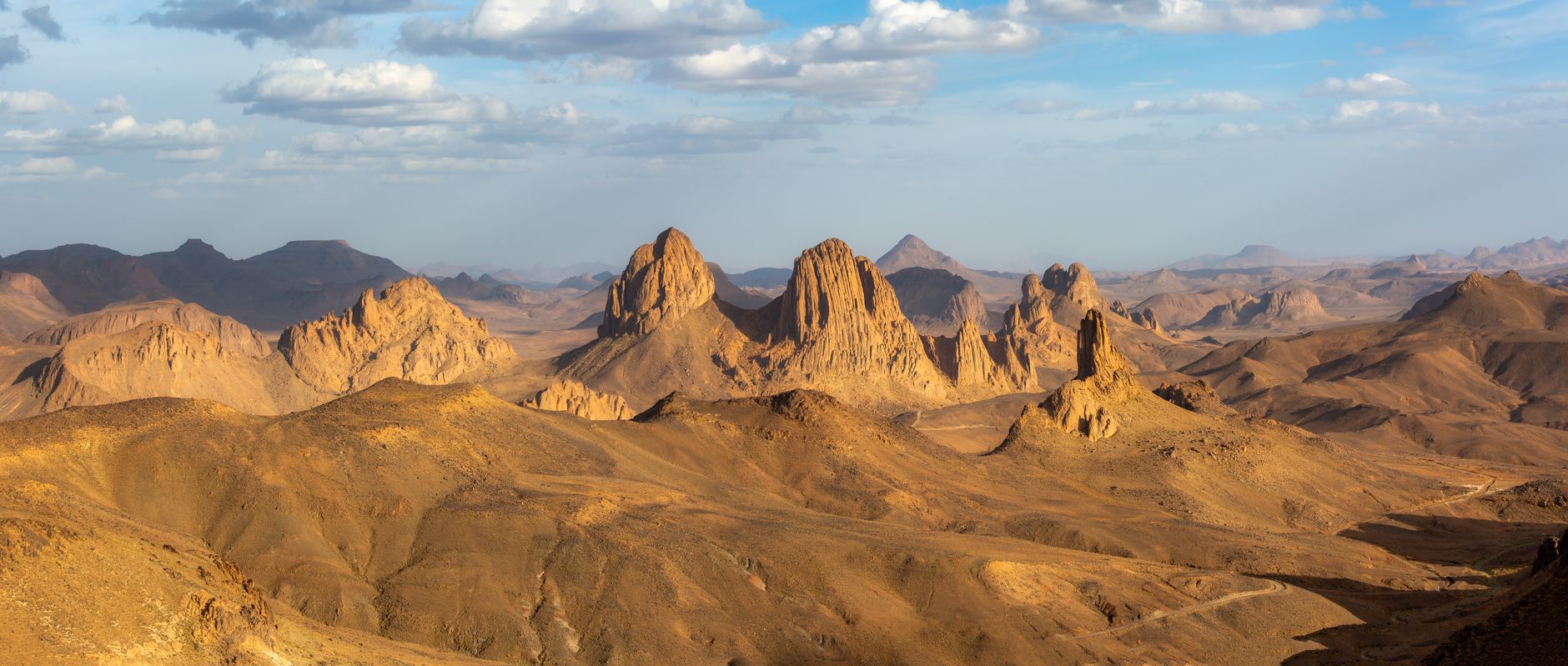 Vast sandstone plateau in the Saharan desert under a wide blue sky