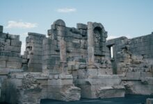 Ancient Roman temple columns standing against a clear sky at an archaeological site in Tunisia