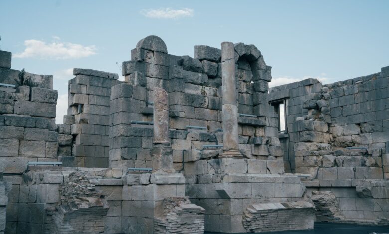 Ancient Roman temple columns standing against a clear sky at an archaeological site in Tunisia