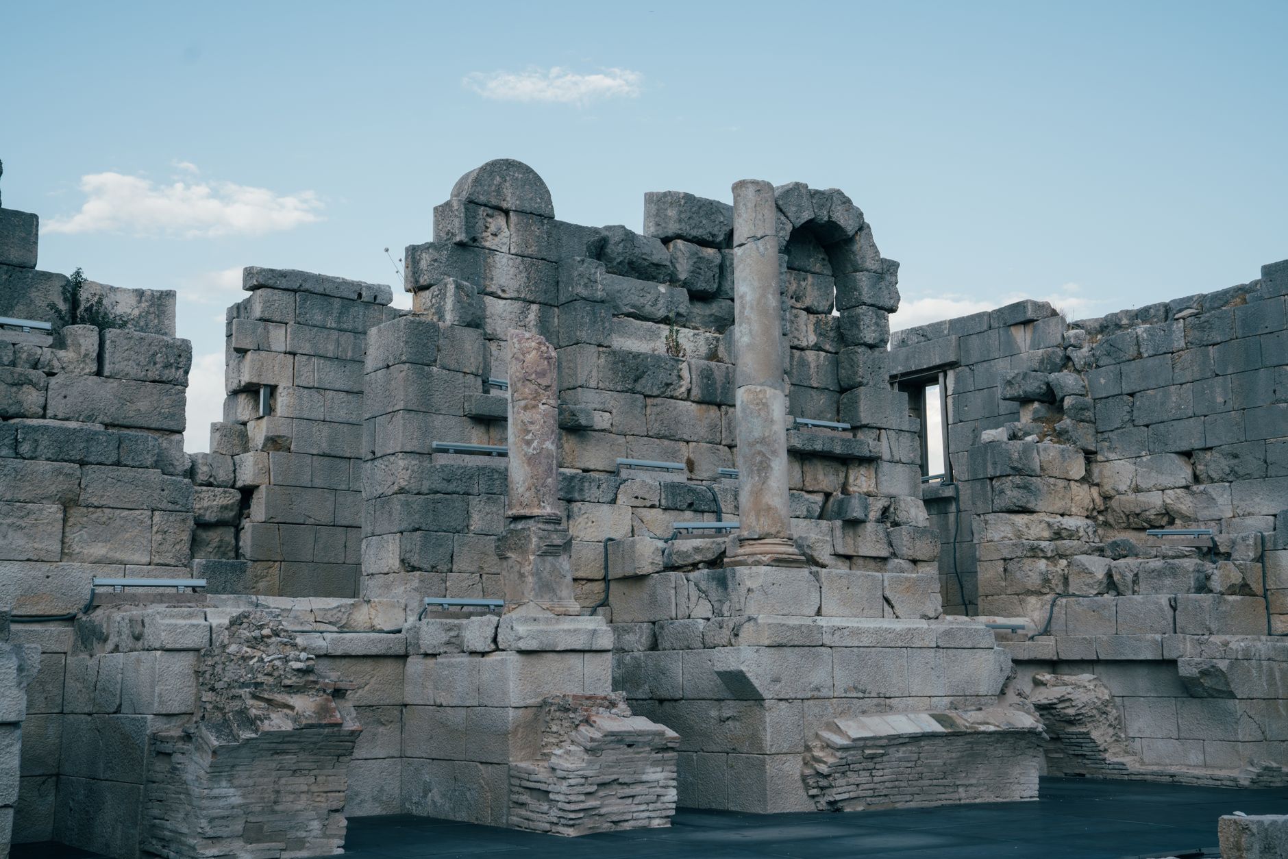 Ancient Roman temple columns standing against a clear sky at an archaeological site in Tunisia