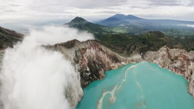 Aerial view of Quilotoa volcanic crater lake with turquoise water in the Ecuadorian Andes