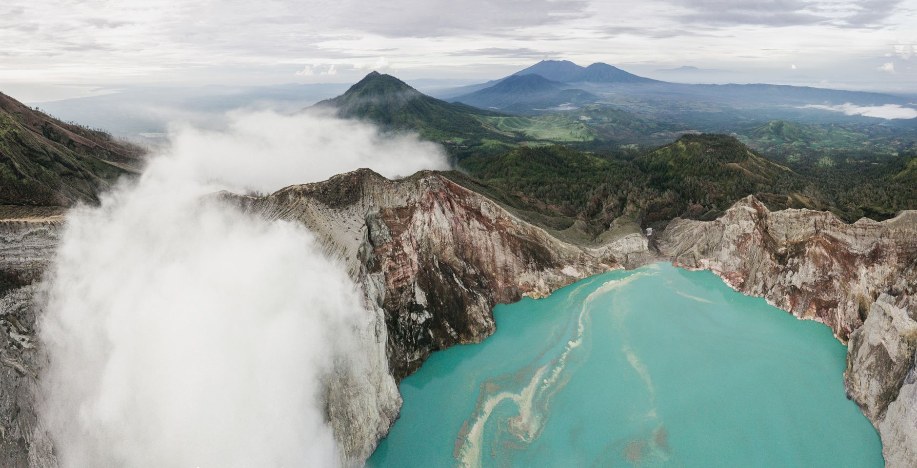 Aerial view of Quilotoa volcanic crater lake with turquoise water in the Ecuadorian Andes
