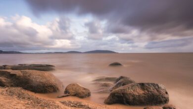 Clear blue waters of Lake Nyasa with rocky shoreline in Malawi