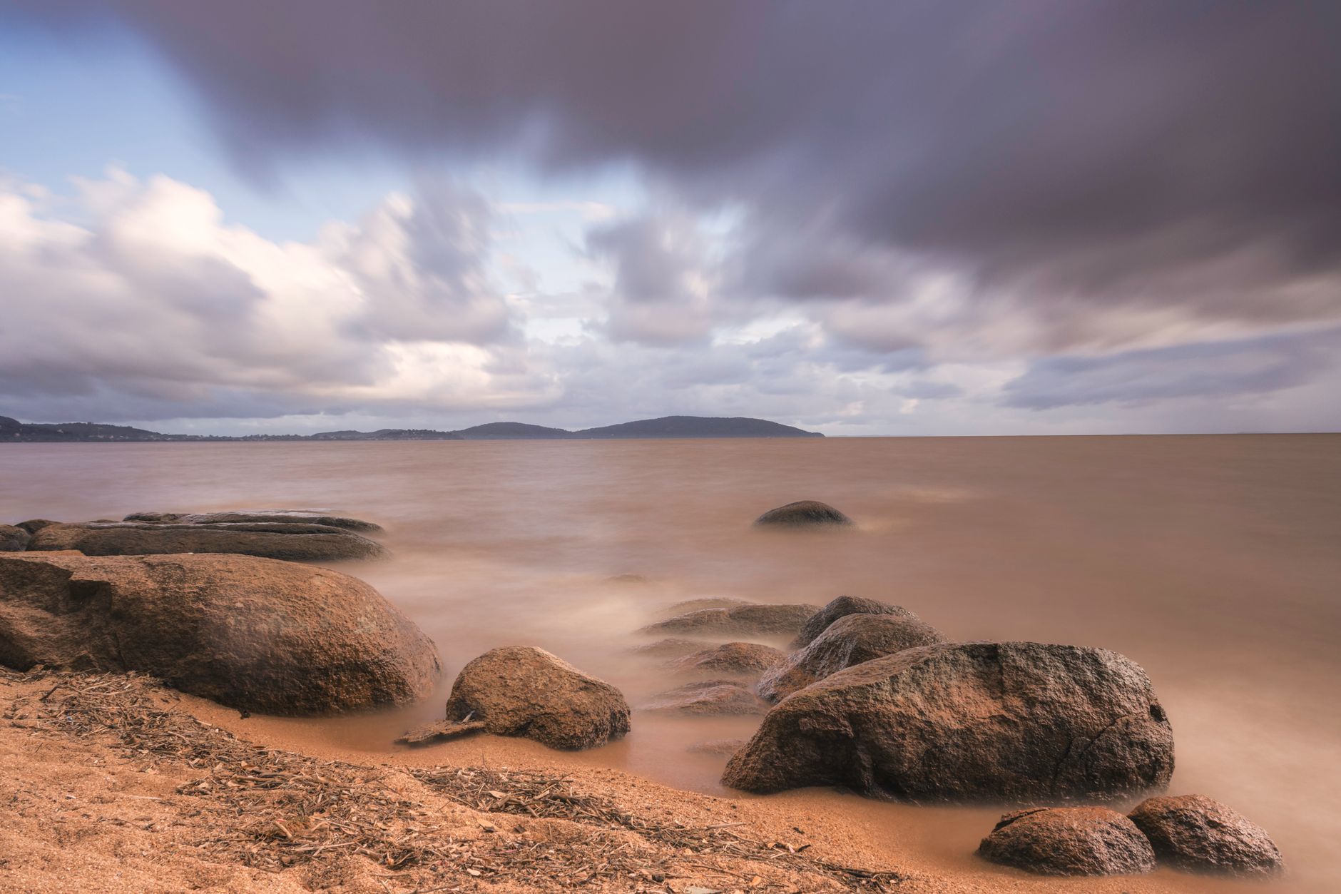 Clear blue waters of Lake Nyasa with rocky shoreline in Malawi