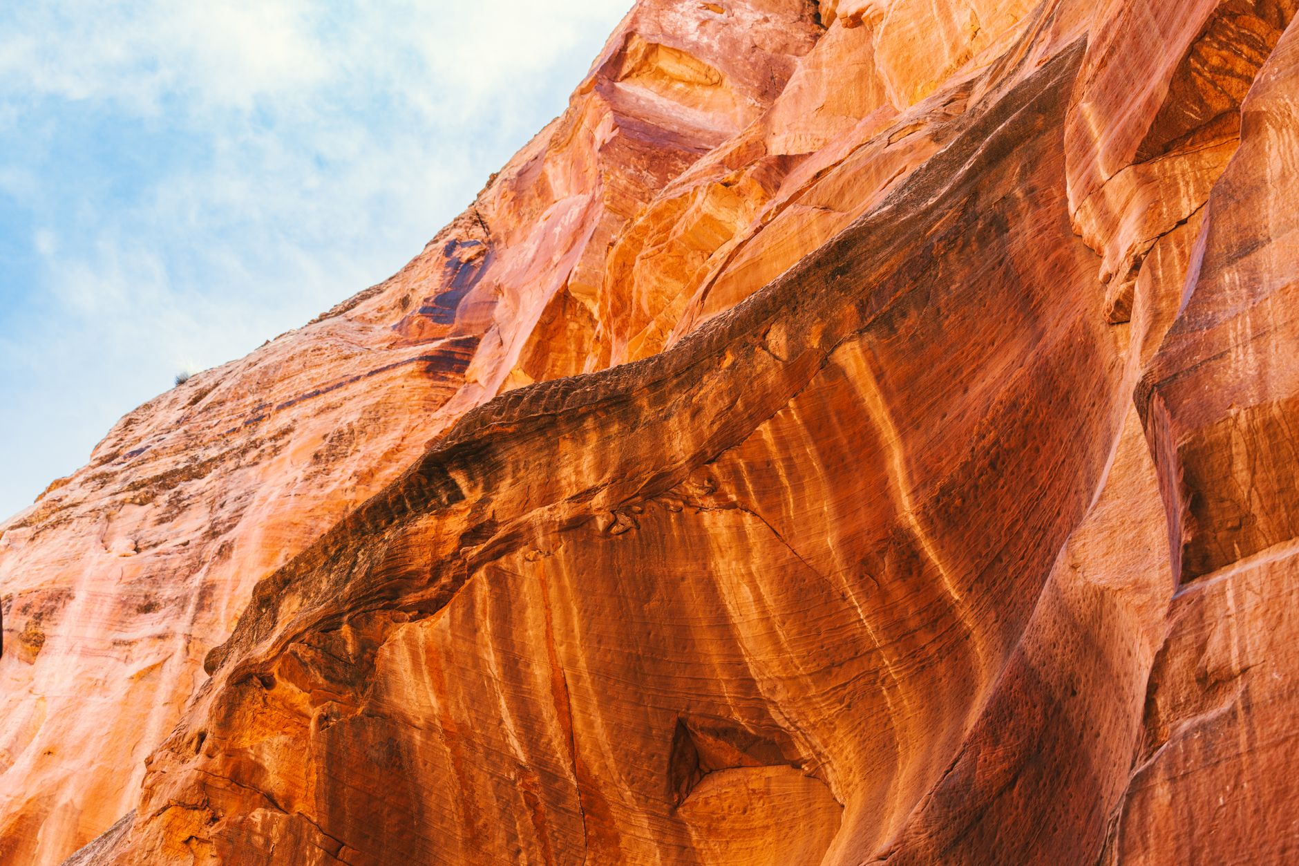 Narrow rock canyon with warm amber light filtering through sandstone walls