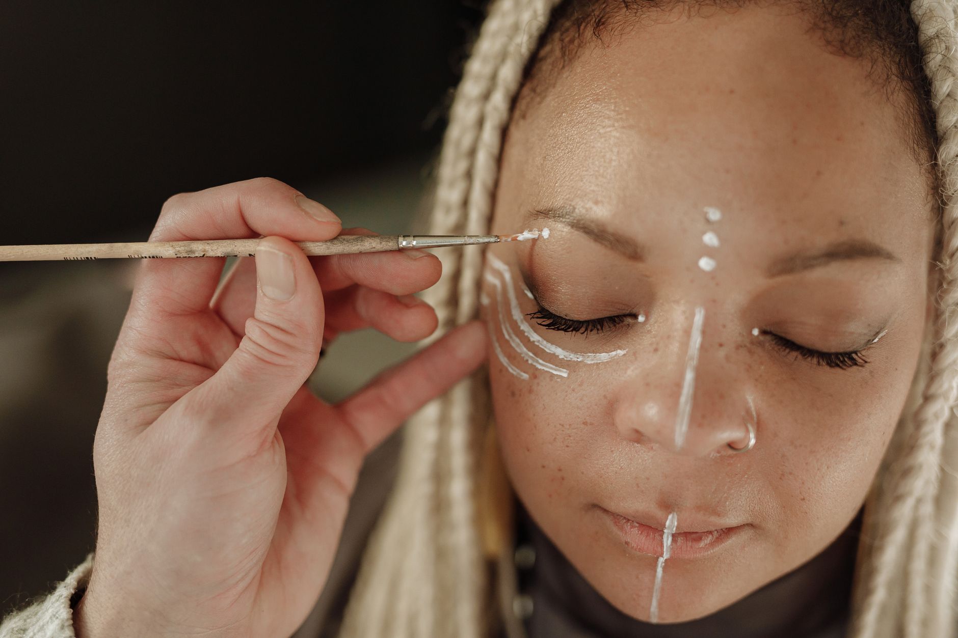 Close-up of traditional body painting patterns in vibrant earth tones