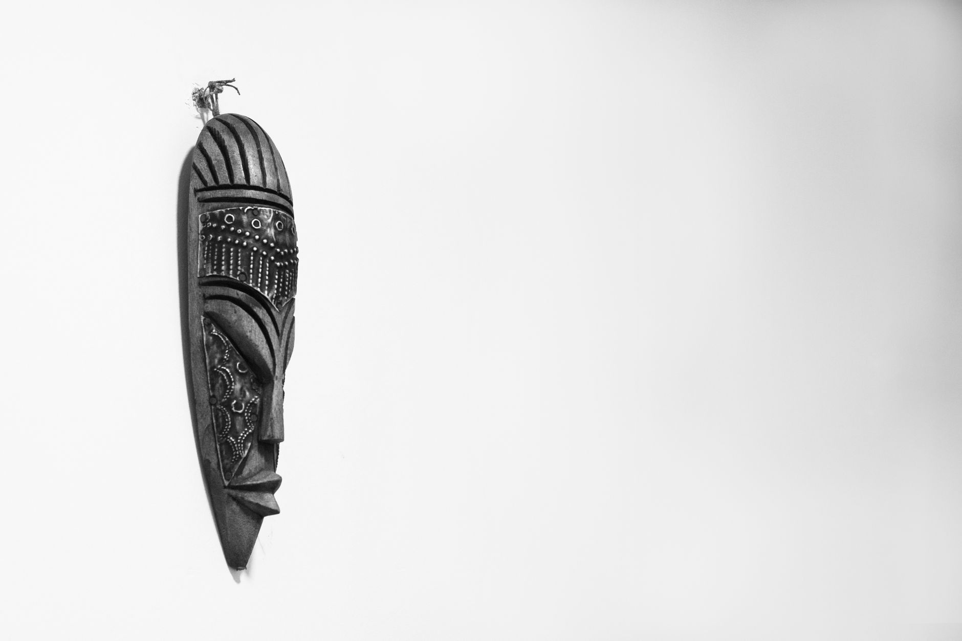 Intricate ancestral wood carvings displayed in a traditional spirit house