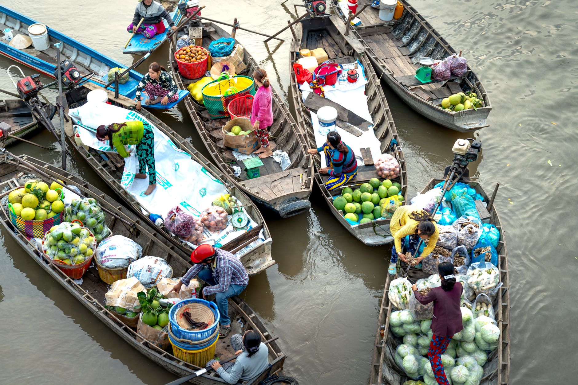Vendors selling goods from boats at a traditional floating market
