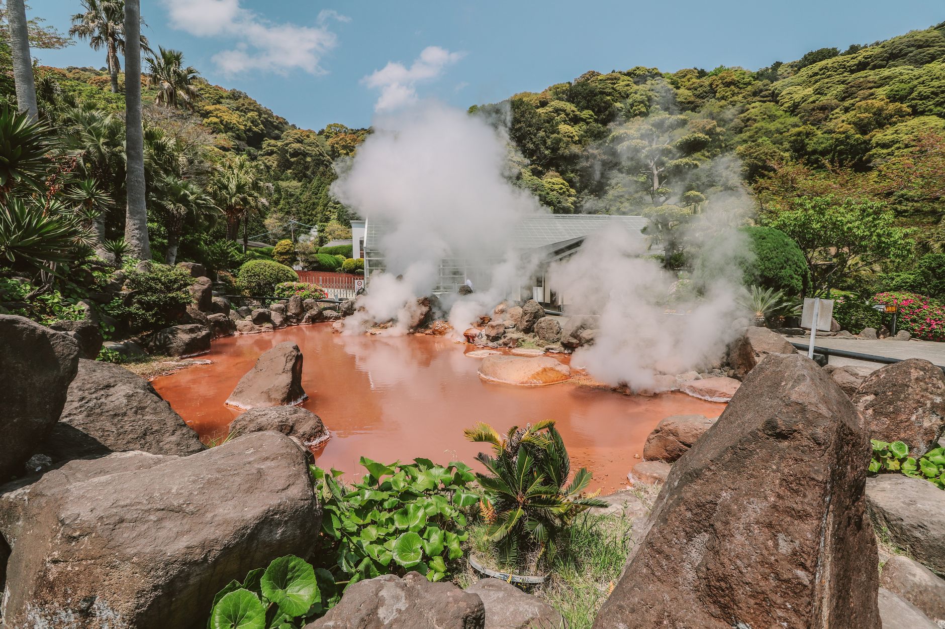 Colorful mineral deposits surrounding acidic hot springs in a volcanic landscape
