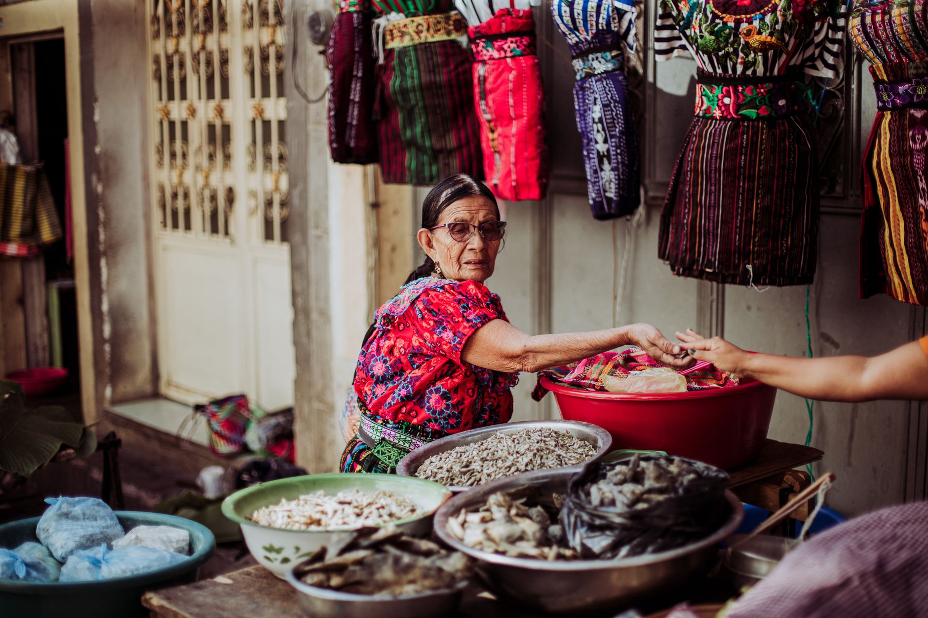 Colorful handwoven wool textiles displayed at an indigenous market in Ecuador
