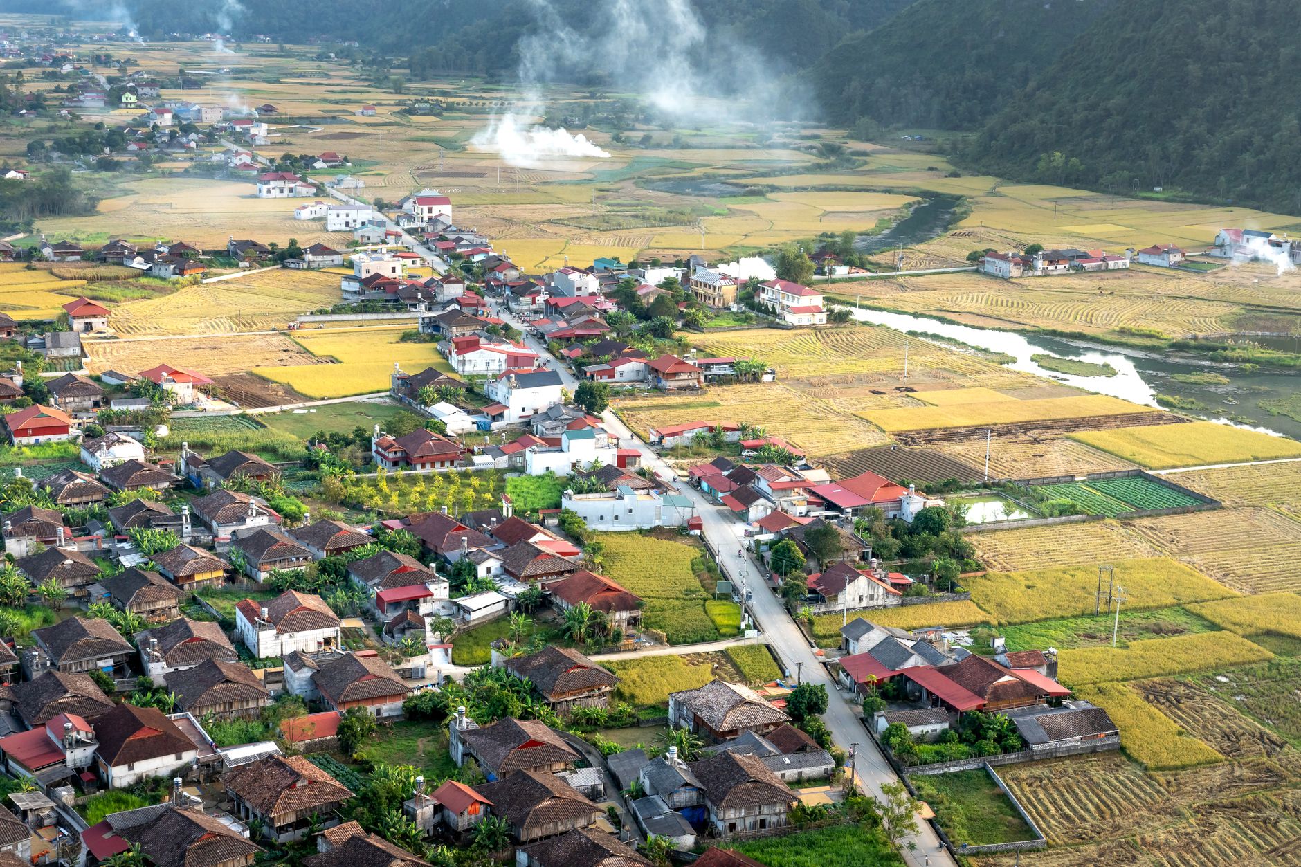 Traditional Andean village surrounded by terraced fields and mountain peaks