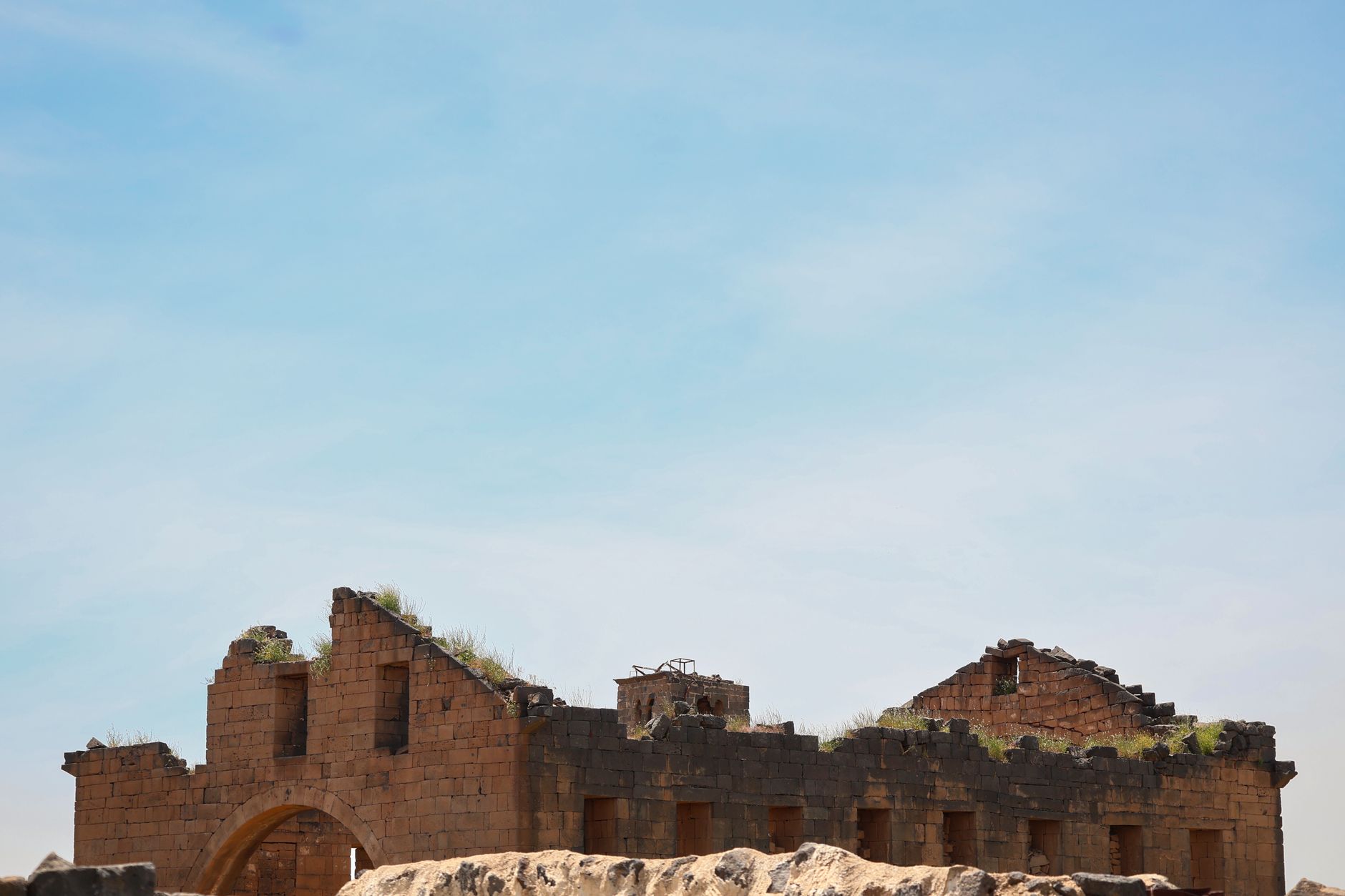 Ancient stone ruins on a headland overlooking a lagoon in the Dhofar region of Oman