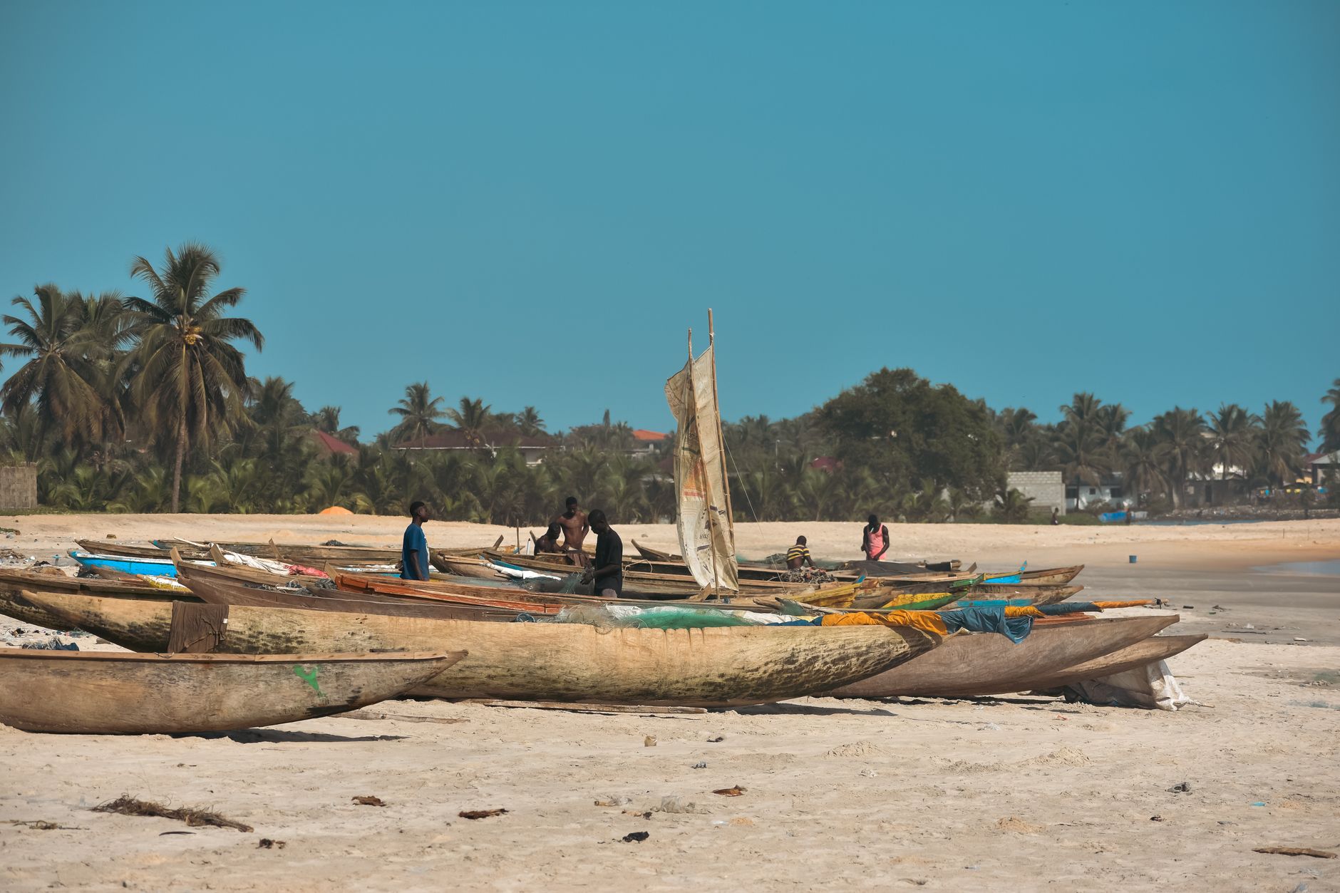 Traditional wooden fishing boats on the shore of an East African lake at dawn
